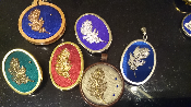 Feather design brooches and pendants